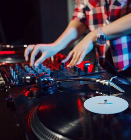 DJ mixing songs with his sound board