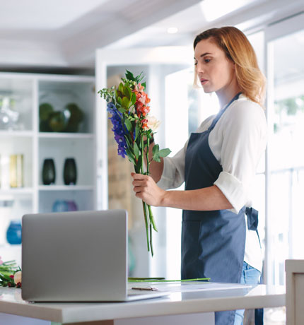 florist arranging flowers in her shop