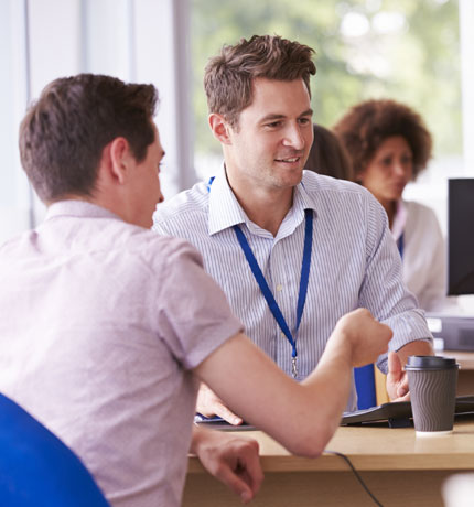 Life coach sitting a a table working with a client 