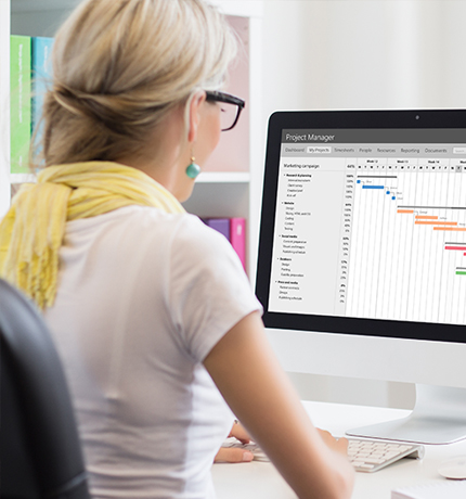 women on a computer reviewing a spreed sheet