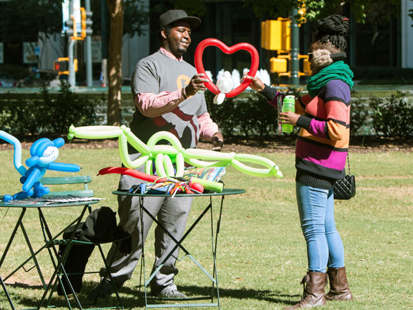 balloon artist working in a park