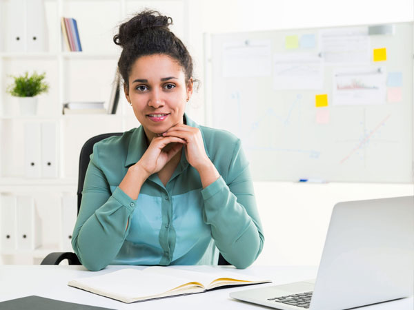 women sitting at her desk organizing her schedule